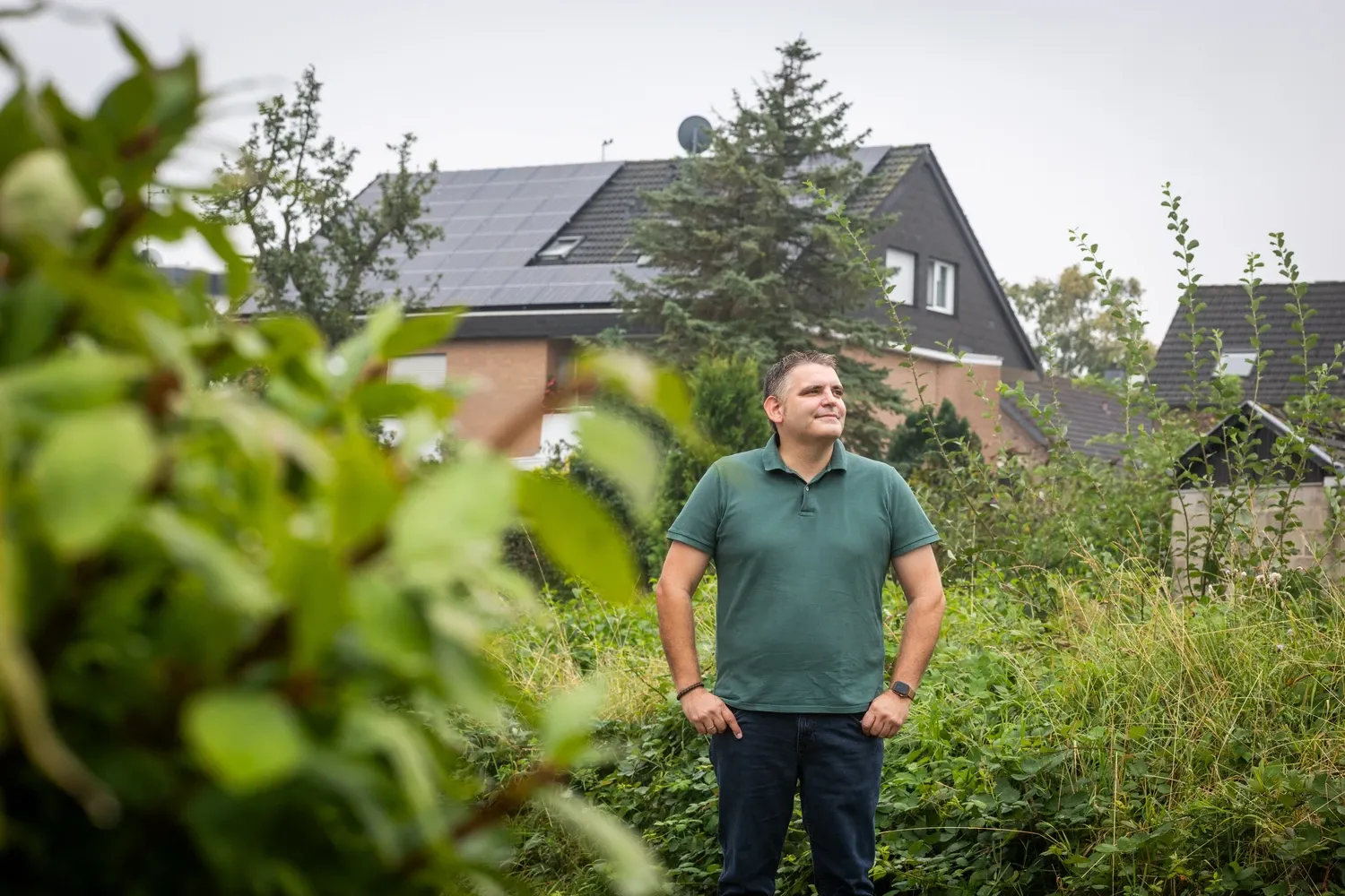 Alex in front of house with solar panels