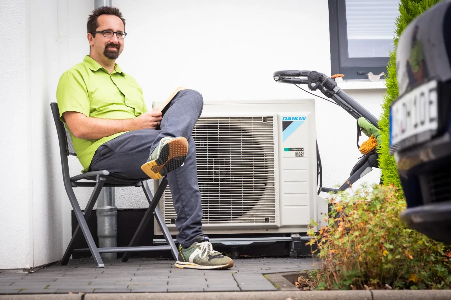 Gunther sits next to Daikin heat pump