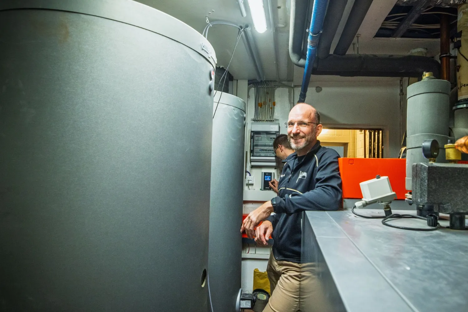 Michael in technical room with hot water storage